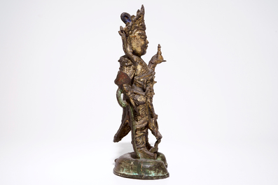 A tall Chinese gilt bronze figure with traces of polychromy, Ming