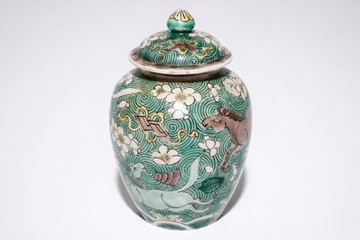 A Chinese verte biscuit covered jar with horses, Kangxi