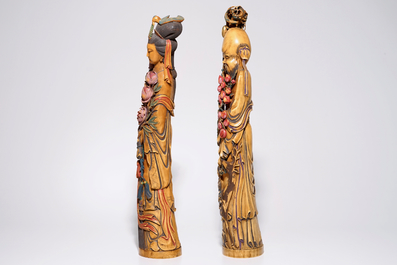 A pair of tall polychrome Chinese carved ivory figures of immortals, 19th C.