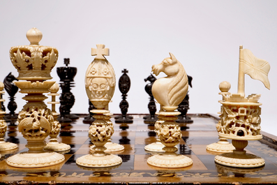 A fine Chinese lacquer chess and backgammon board with ivory game pieces, 19th C.