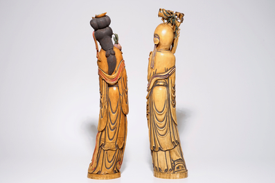 A pair of tall polychrome Chinese carved ivory figures of immortals, 19th C.