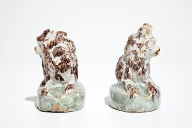 A pair of polychrome Brussels faience models of dogs, 18th C.