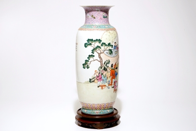 A large Chinese famille rose vase with playing boys, on a wooden stand, 20th C.