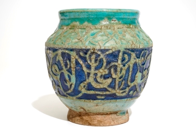 A turquoise and blue glazed calligraphy vase, Kashan, Iran, 12/13th C.