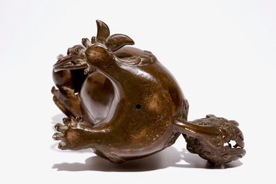 A Chinese lacquered bronze censer modelled as a buddhist lion with a brocade ball, Ming