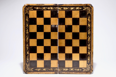 A fine Chinese lacquer chess and backgammon board with ivory game pieces, 19th C.