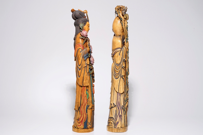 A pair of tall polychrome Chinese carved ivory figures of immortals, 19th C.