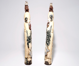 A pair of tall polychrome Chinese carved ivory figures of immortals, 19th C.