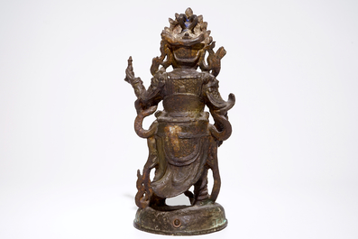 A tall Chinese gilt bronze figure with traces of polychromy, Ming