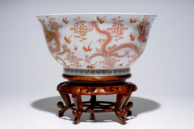 A large Chinese famille rose &quot;dragon&quot; bowl on a wooden stand, 20th C.