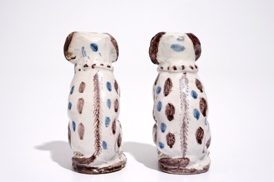 A pair of blue and manganese Brussels faience models of dogs, 18th C.