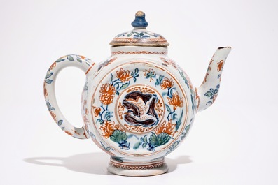 A Dutch Delft cashmire palette teapot with birds and insectes among flowers, early 18th C.