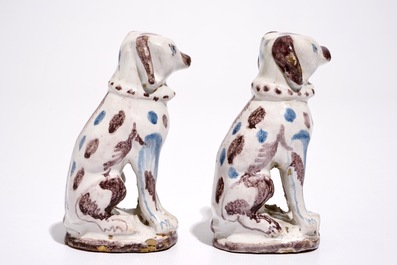 A pair of blue and manganese Brussels faience models of dogs, 18th C.