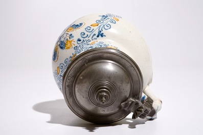 An Italian maiolica compendario style jug with a putto, Faenza, 17th C.