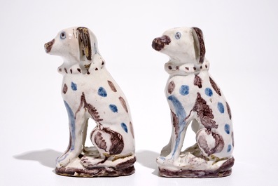 A pair of blue and manganese Brussels faience models of dogs, 18th C.
