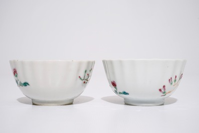 A pair of Chinese famille rose cups and saucers with peacocks, Qianlong