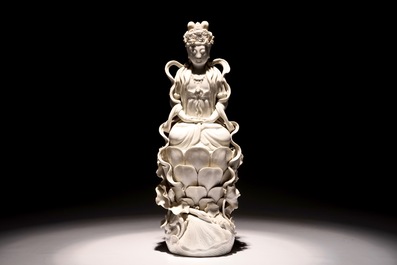A tall Chinese Dehua blanc de Chine Guanyin seated on a lotus flower, 19/20th C.
