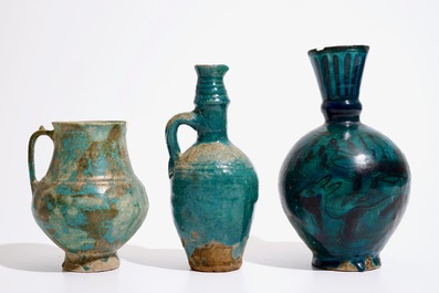 Three Islamic turquoise glazed jugs, incl. Raqqa and Iran, 14th C. and later