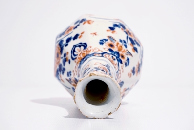 A Dutch Delft bottle vase with a floral chinoiserie design in red and blue, 1st quarter 18th C.