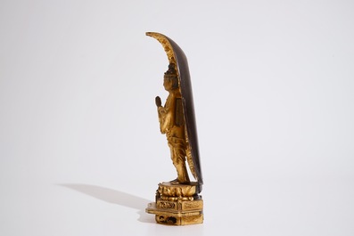 A Japanese lacquered and gilt wood &quot;Zushi&quot; shrine with a standing Buddha on a lotus throne, Edo, 17/18th C.