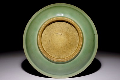 A Chinese celadon dish with incised lotus design, 19th C.