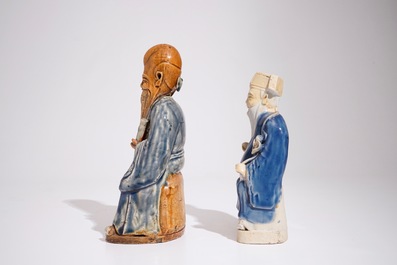 Two Chinese blue and white glazed biscuit figures of immortals, Qianlong
