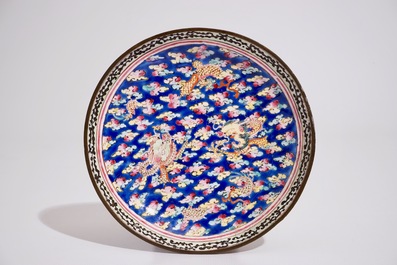 A Chinese Canton enamel blue ground dragon cup and saucer, 19th C.