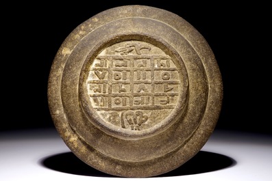 A low-fired carved stone Islamic calligraphy dish with a magic square, 16/17th C.