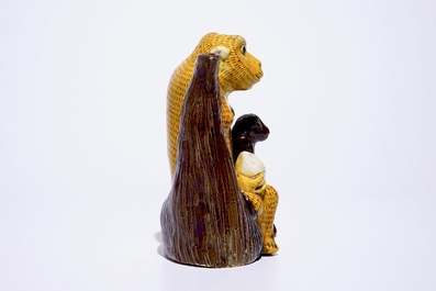 A Chinese yellow and aubergine glazed biscuit ewer in the shape of two monkeys with peaches, Kangxi