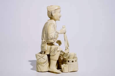 A Japanese ivory okimono of a vegetable seller, Meiji, early 20th C.