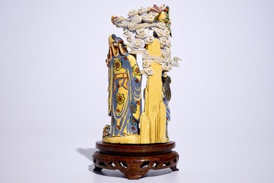 A polychrome Chinese ivory group of an immortal with children, early 20th C.