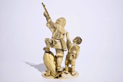 A Japanese ivory okimono of a hunter and his son, Meiji, late 19th C., signed