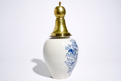 A Dutch Delft blue and white tobacco jar with brass cover, 18th C.