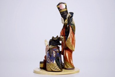 A polychrome Japanese ivory okimono of ladies presenting a gift, Meiji, early 20th C.