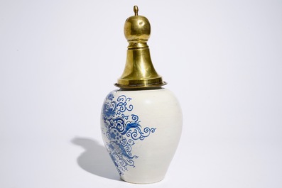 A Dutch Delft blue and white tobacco jar with brass cover, 18th C.