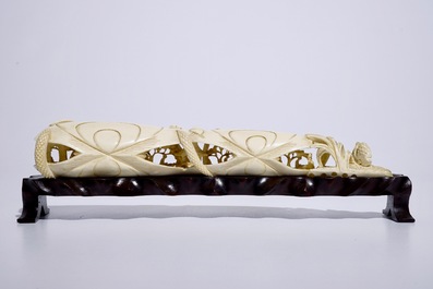 A Chinese shell-shaped ivory group on wooden stand, early 20th C.