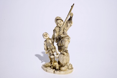 A Japanese ivory okimono of a hunter and his son, Meiji, late 19th C., signed