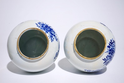 A pair of Dutch Delft blue and white tobacco jars with brass covers, 19th C.