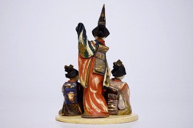 A polychrome Japanese ivory okimono of ladies presenting a gift, Meiji, early 20th C.
