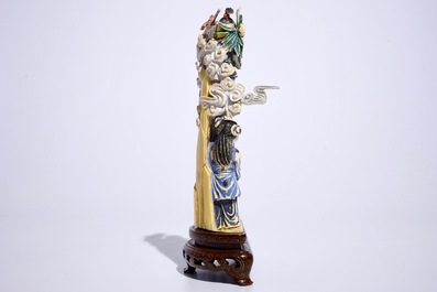 A polychrome Chinese ivory group of an immortal with children, early 20th C.