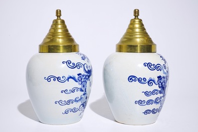 A pair of Dutch Delft blue and white tobacco jars with brass covers, 19th C.