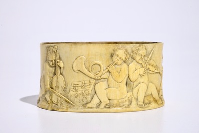 A finely carved ivory box with boys playing music, probably French, 18/19th C.