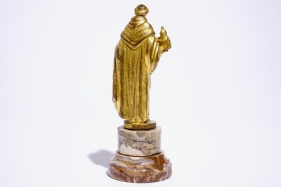 A gilt bronze model of a saint on a later marble base, 17th C.