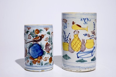 Two polychrome Dutch Delft mugs with birds, vases and flowers, 18th C.