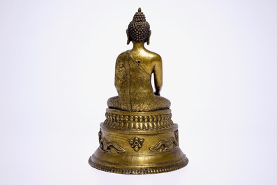 A gilt bronze model of Buddha seated on a throne, Nepal or Tibet, 19/20th C.