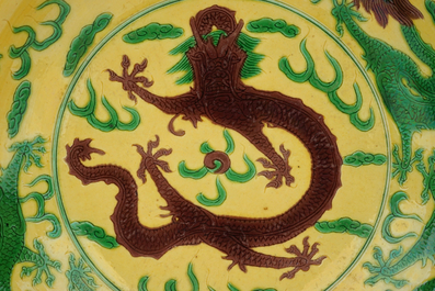 A Chinese yellow-ground green and aubergine enameled dragon dish, Kangxi mark, 19th C.