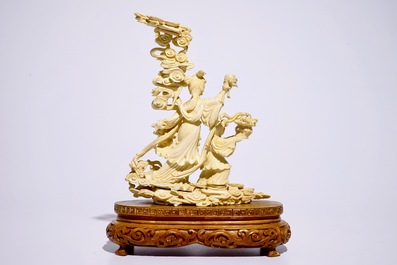 A Chinese carved ivory group of Lan Cai He with a servant, early 20th C.