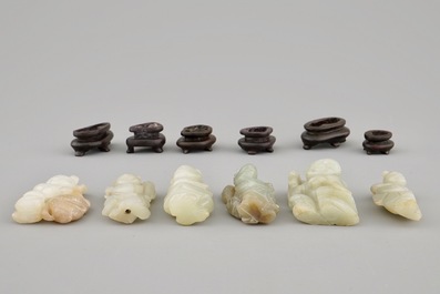 Ten various small jade carvings on wooden bases, 19/20th C.