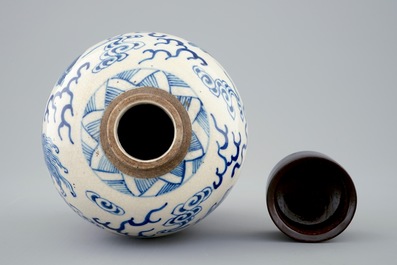 A Chinese blue and white soft paste jar with wooden cover, 19th C.