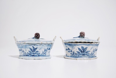 A pair of Dutch Delft blue and white butter tubs with blackberry finials, 18th C.